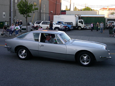 [A silver two-door car with a squarish shape.]